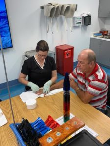 Miami Hand Center staff assisting patient therapy wide angle