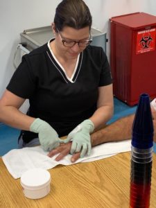 Miami Hand Center staff assisting patient therapy